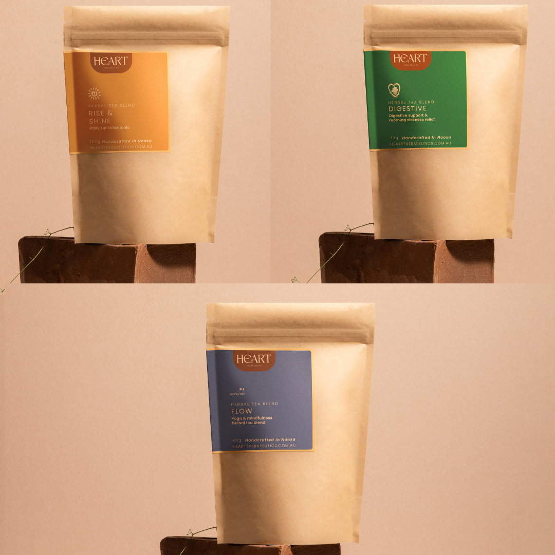 Three packages of Heart Tea Blend with different colored labels on a neutral background.