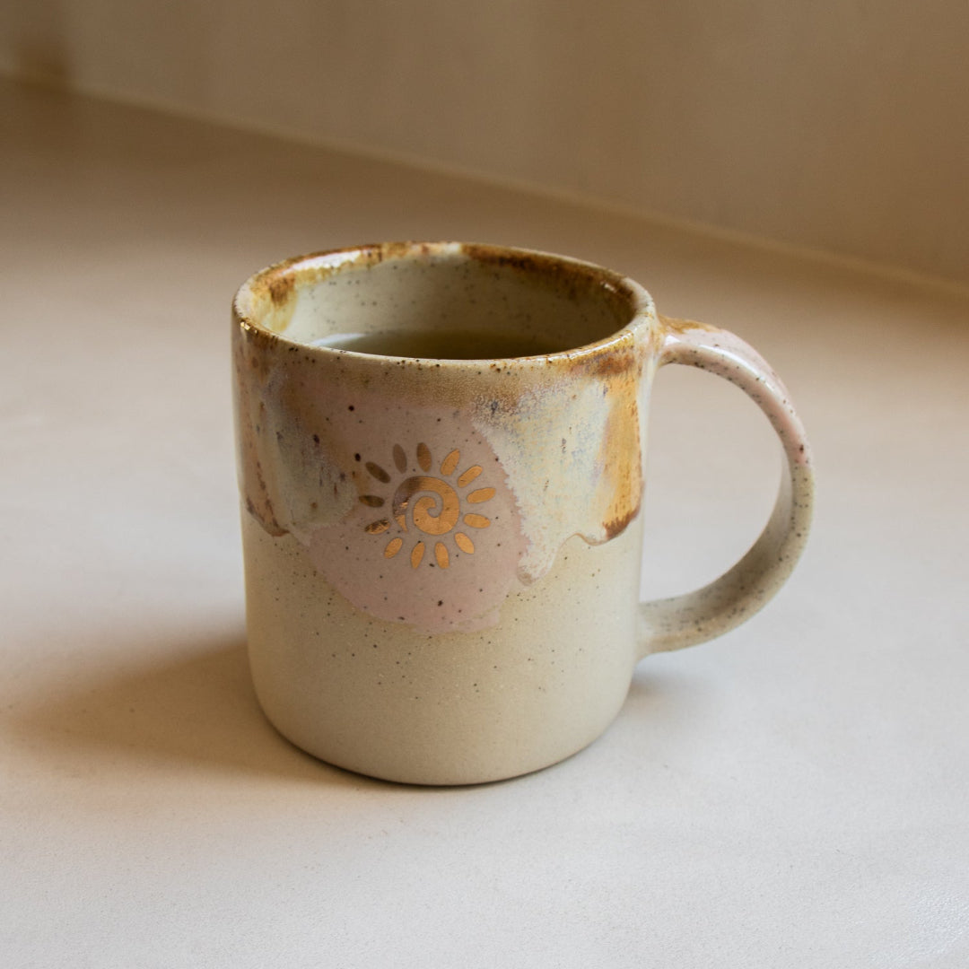 Ceramic mug with decorative design on a neutral background