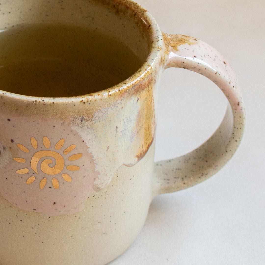 Ceramic mug with sun design on a light background