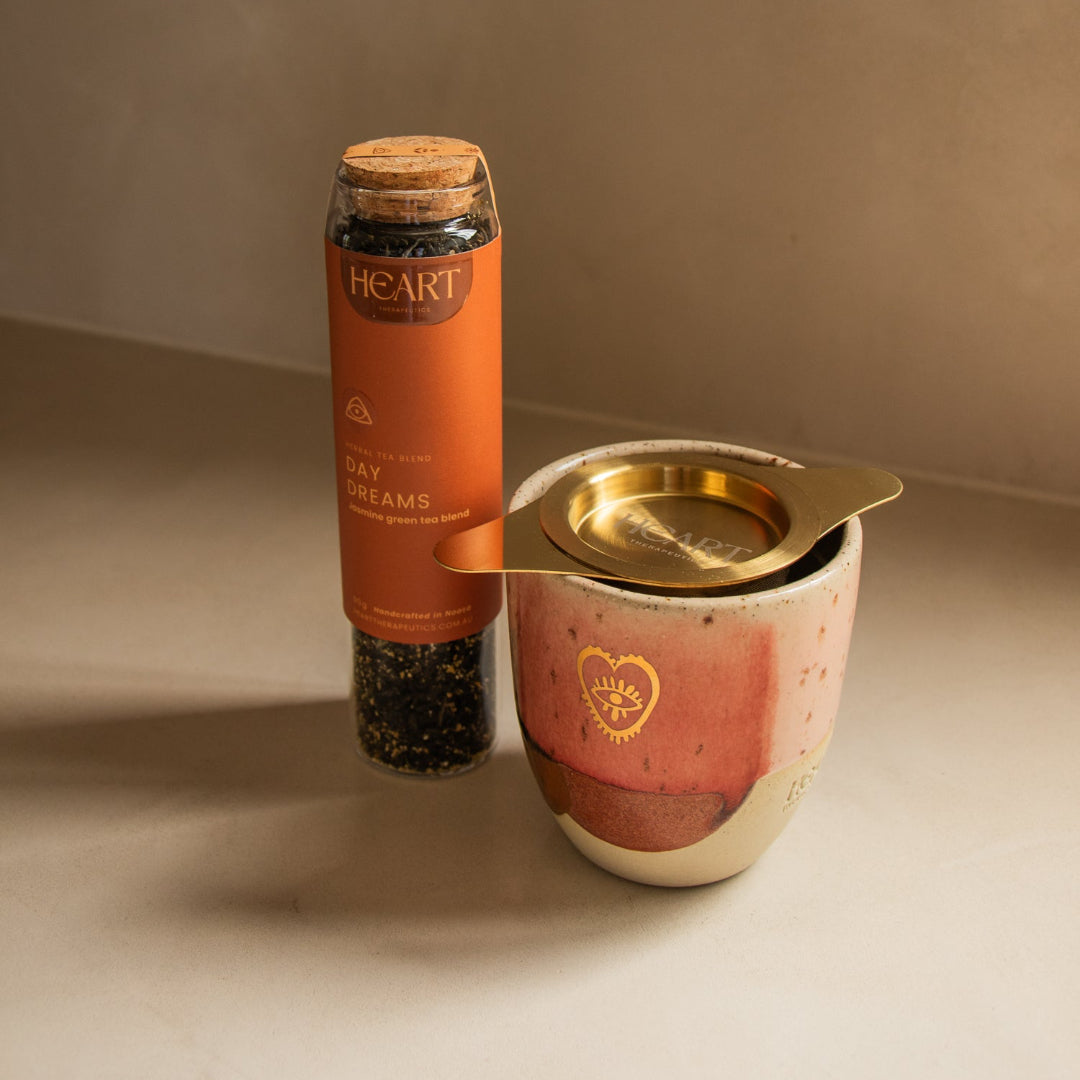 Candle and container with 'Heart' branding on a neutral background