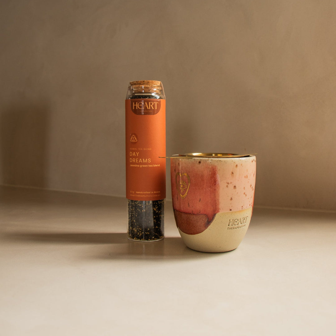 Cylindrical container with a label and a ceramic cup on a neutral background